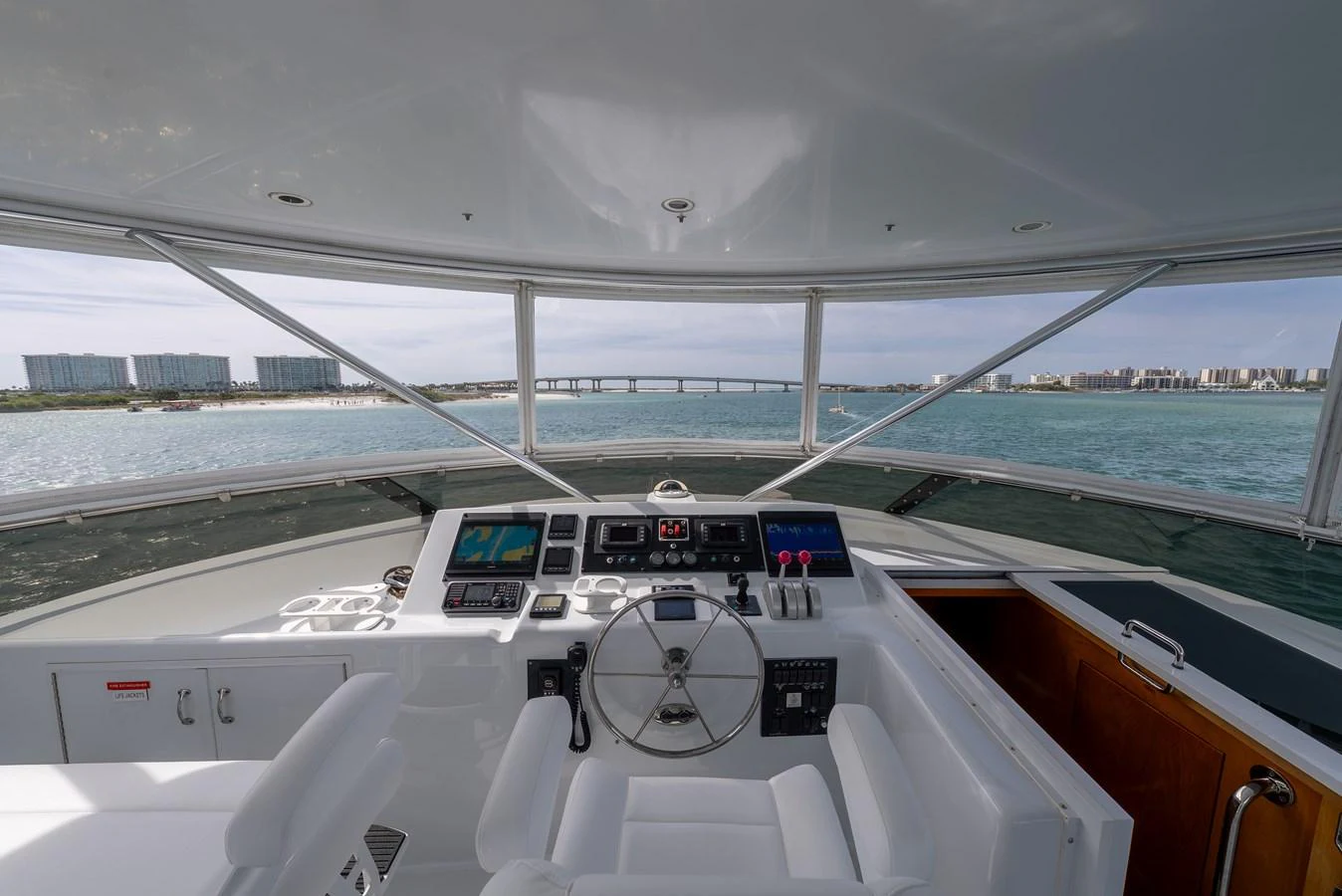 The helm offers a commanding view of the surrounding waters and cityscape, equipped with modern navigation instruments. aboard HAVILAH Yacht for Sale