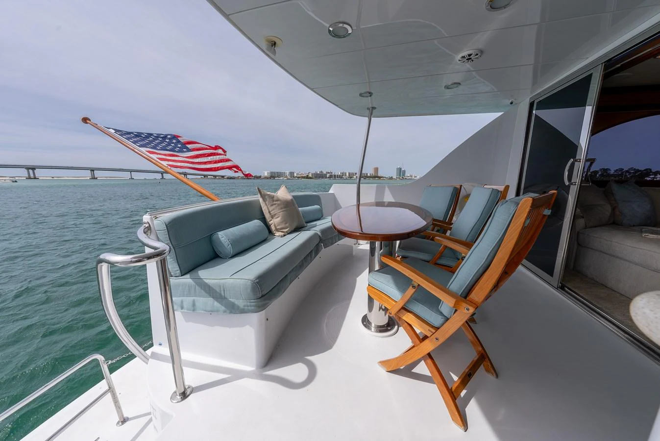 The aft deck features comfortable seating with a table, perfect for enjoying the view. aboard HAVILAH Yacht for Sale