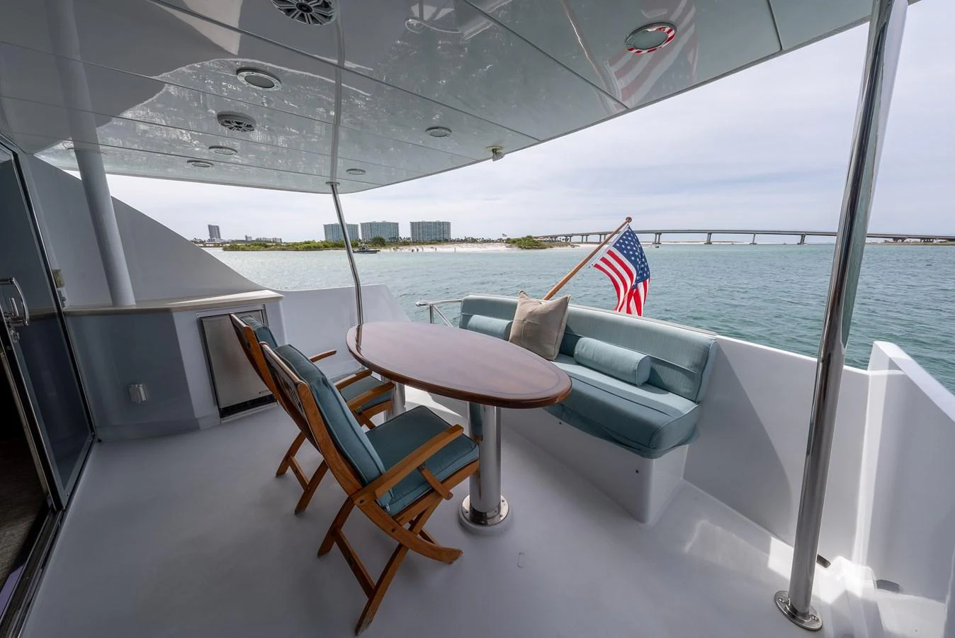 The aft deck offers a relaxing seating area with a table and chairs, perfect for enjoying the view. aboard HAVILAH Yacht for Sale
