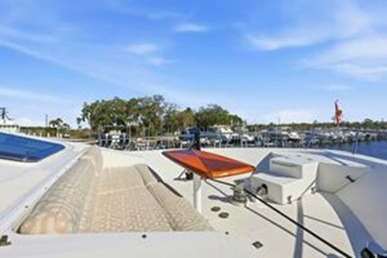 The foredeck features a spacious sunbathing area with comfortable cushions and a small table, perfect for relaxation. aboard FOOTLOOSE Yacht for Sale