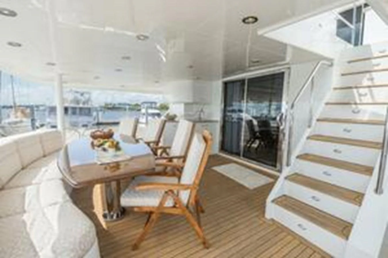 The aft deck features a comfortable seating area with a dining table and chairs, perfect for outdoor meals and relaxation. aboard FOOTLOOSE Yacht for Sale