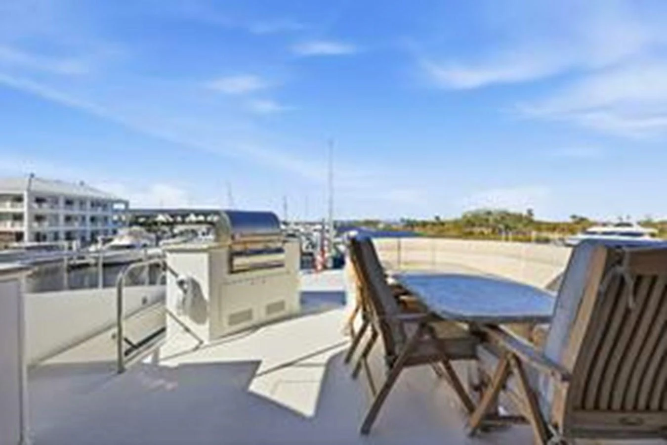 The aft deck features a dining area with a table and chairs, perfect for al fresco meals. aboard FOOTLOOSE Yacht for Sale