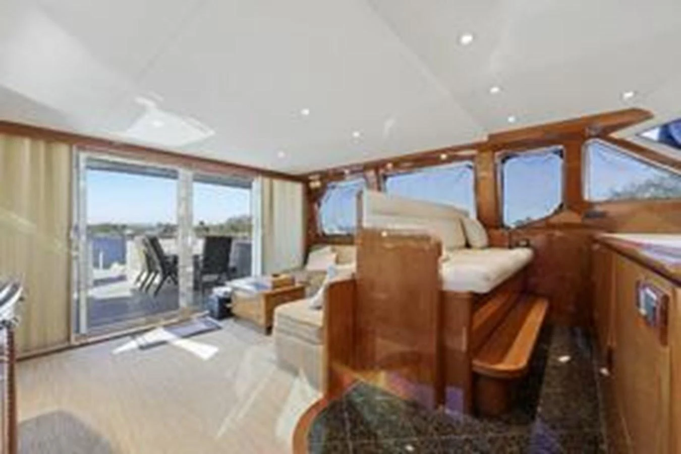 The salon features luxurious seating and ample natural light with a view of the deck. aboard FOOTLOOSE Yacht for Sale
