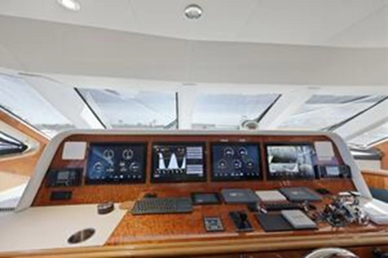 The helm station features advanced navigation equipment and a sleek, modern design. aboard FOOTLOOSE Yacht for Sale