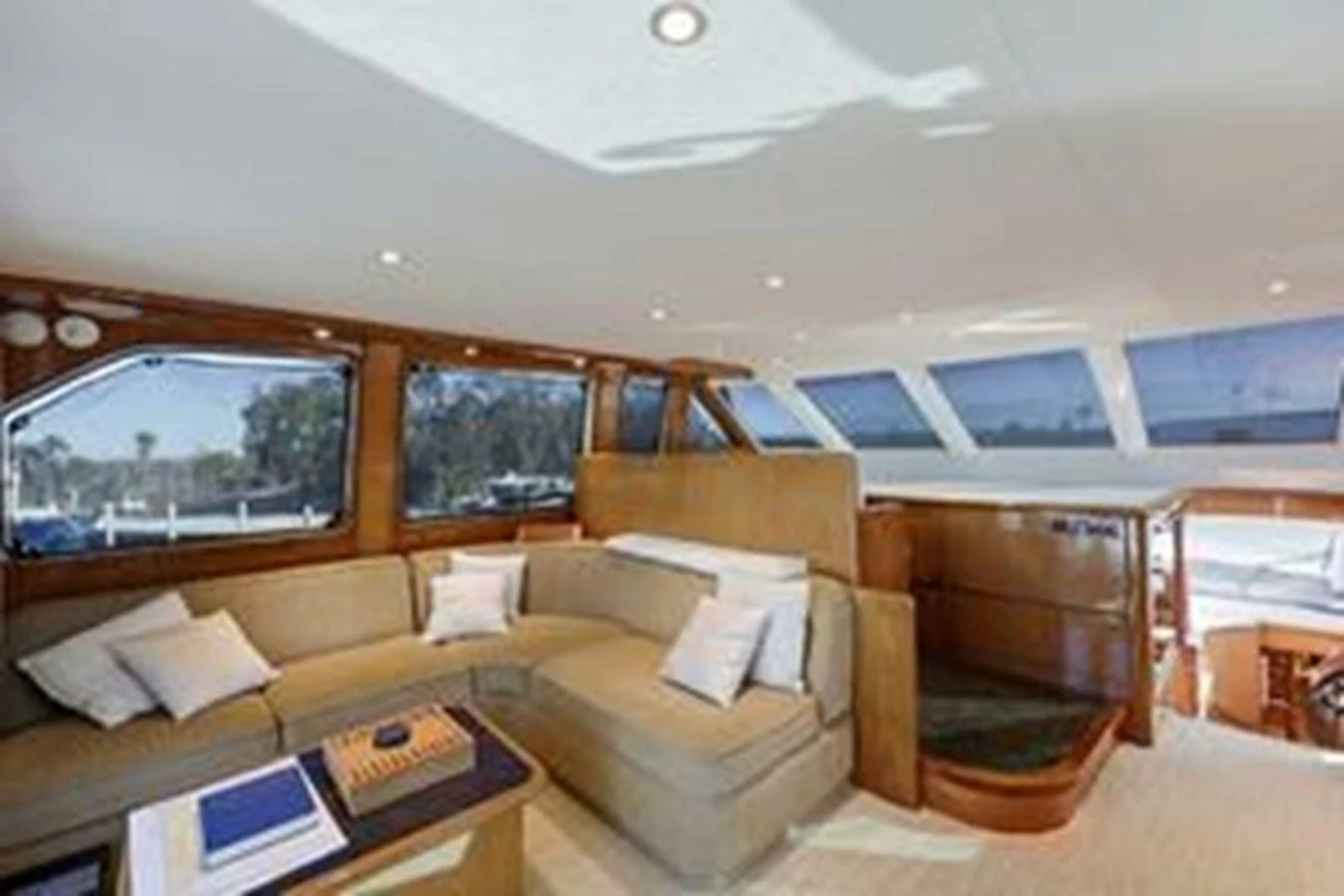 The salon features a spacious seating area with large windows providing ample natural light. aboard FOOTLOOSE Yacht for Sale