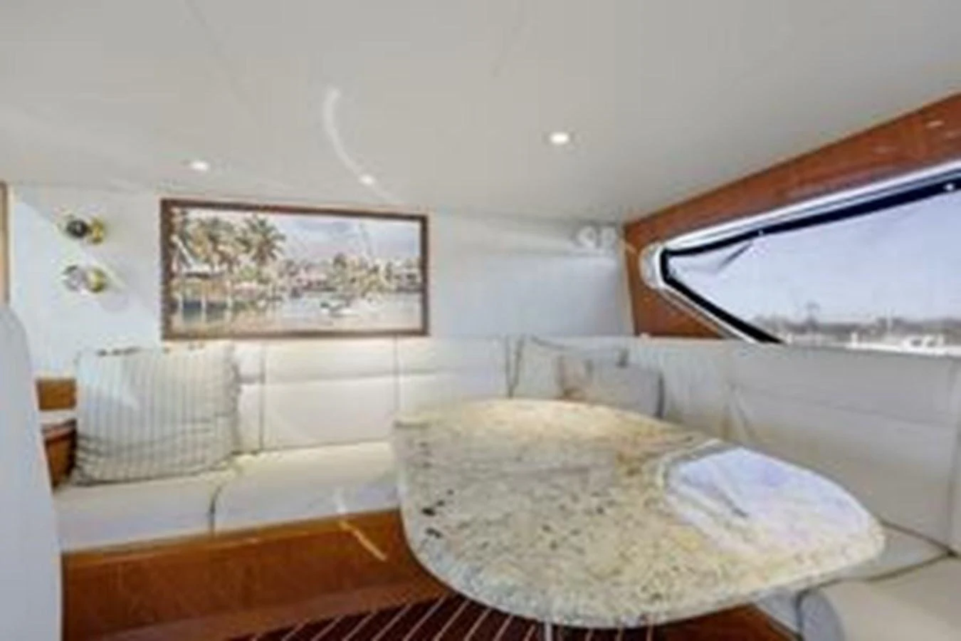 The yacht's dining area features a sleek, modern design with a marble table and comfortable seating. aboard FOOTLOOSE Yacht for Sale