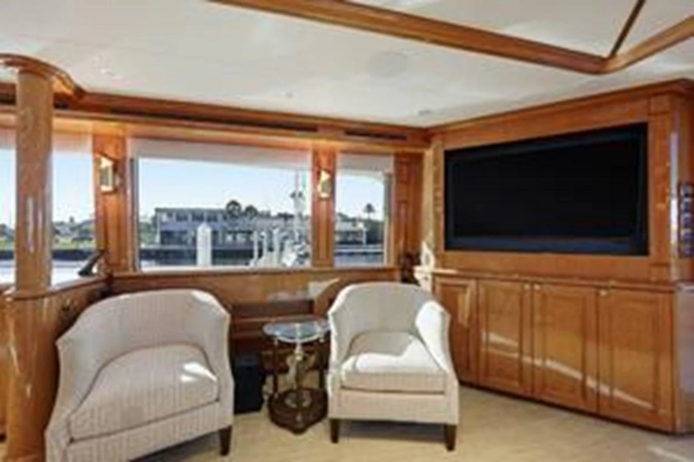 The salon features comfortable seating and a large flat-screen TV, creating a cozy and inviting atmosphere. aboard FOOTLOOSE Yacht for Sale