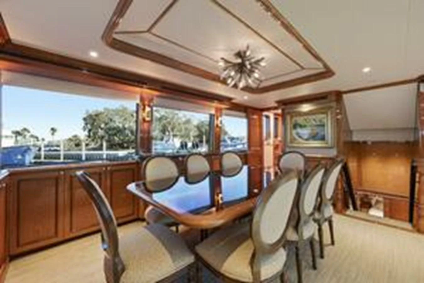 The yacht's dining area features elegant wood paneling and large windows for a scenic view. aboard FOOTLOOSE Yacht for Sale