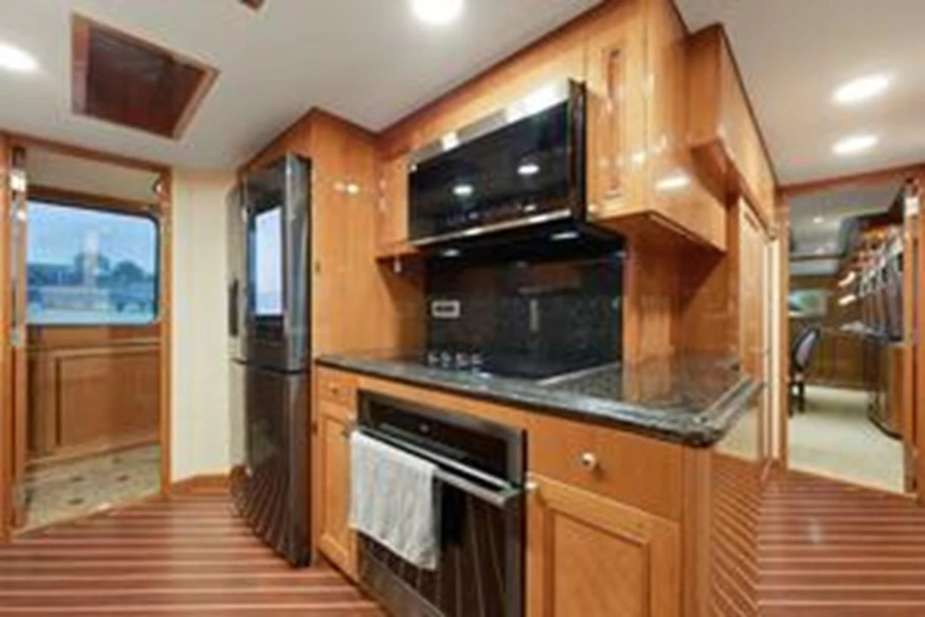 The yacht's galley is equipped with modern appliances and elegant wooden cabinetry. aboard FOOTLOOSE Yacht for Sale