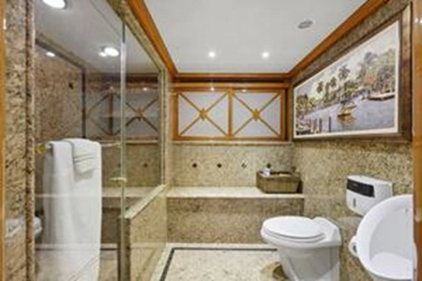 The yacht's bathroom features luxurious stone finishes and modern amenities. aboard FOOTLOOSE Yacht for Sale