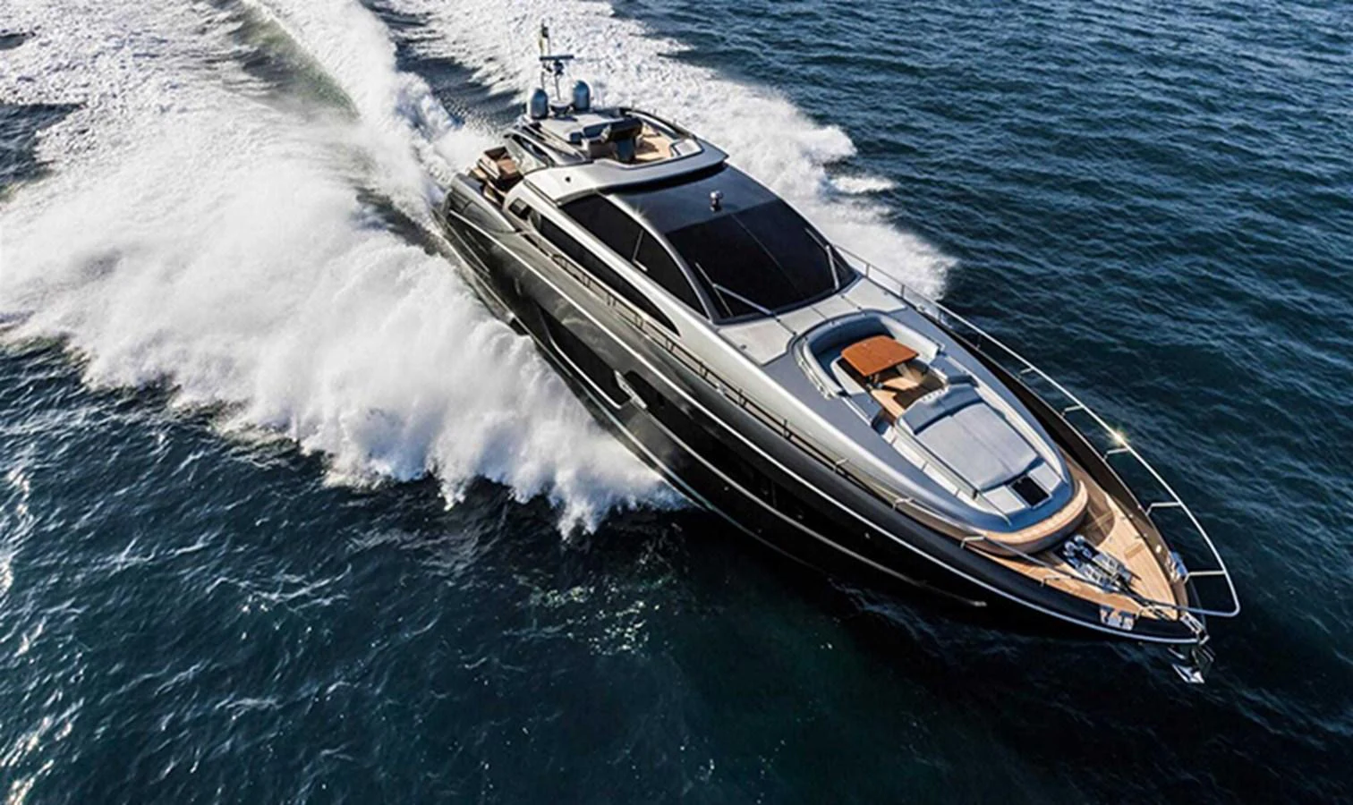 A sleek yacht cuts through the water at high speed, showcasing its elegant design and powerful performance. aboard ANTIOXIDANT Yacht for Sale
