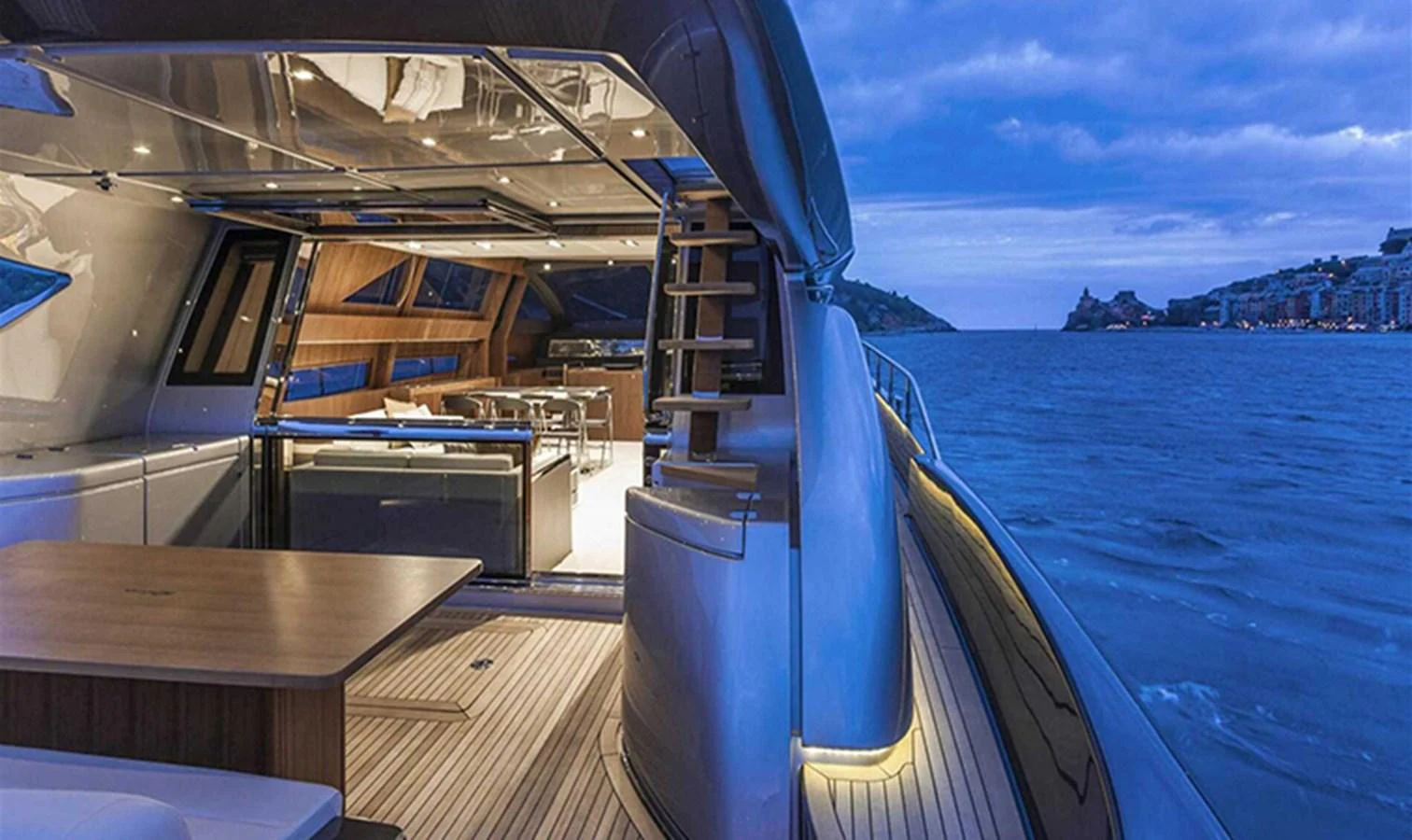 The yacht's aft deck offers a luxurious open-air dining area with stunning views of the surrounding water and coastline. aboard ANTIOXIDANT Yacht for Sale