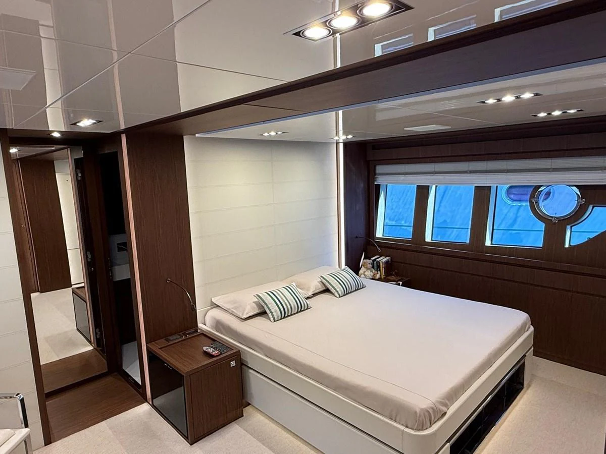 The master stateroom features a luxurious bed with modern decor and ample natural light. aboard ANTIOXIDANT Yacht for Sale