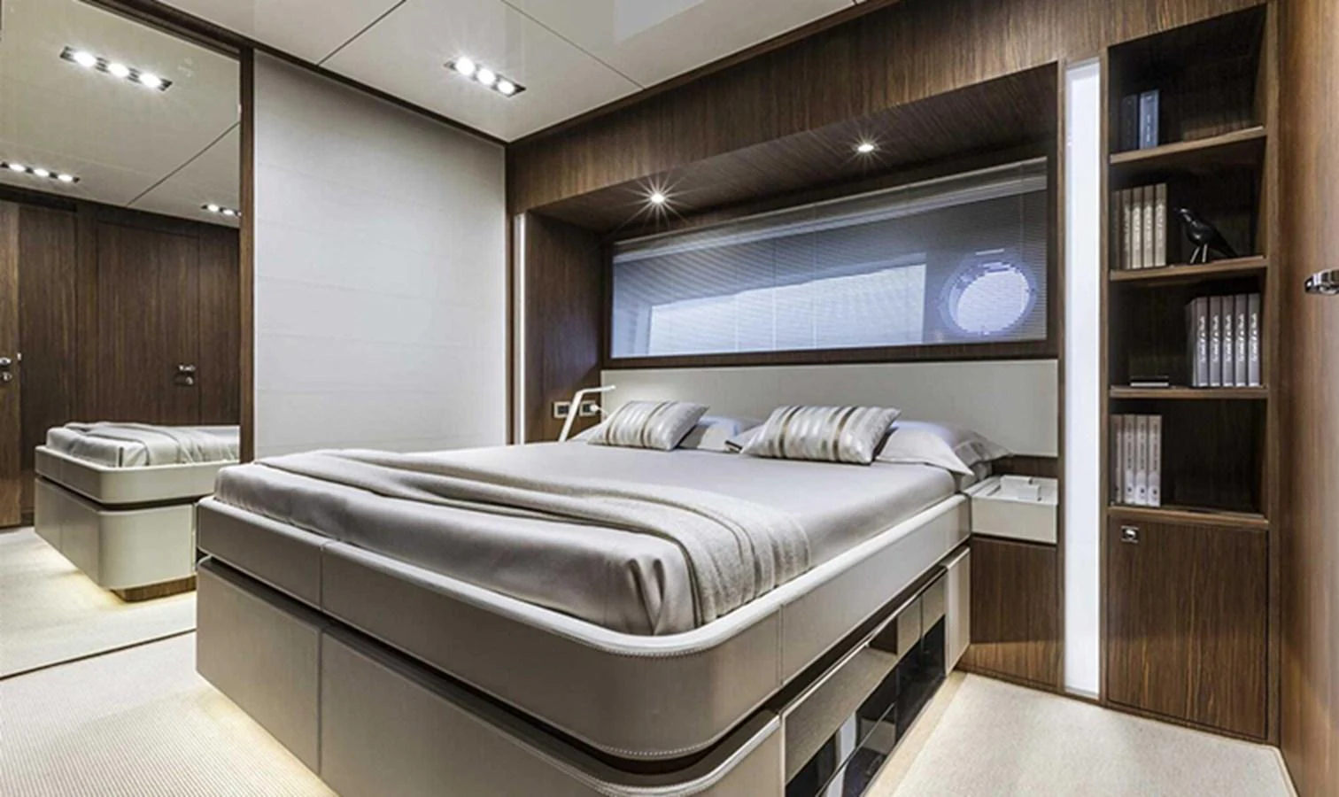 The stateroom features a luxurious bed with modern wood paneling and ample storage. aboard ANTIOXIDANT Yacht for Sale