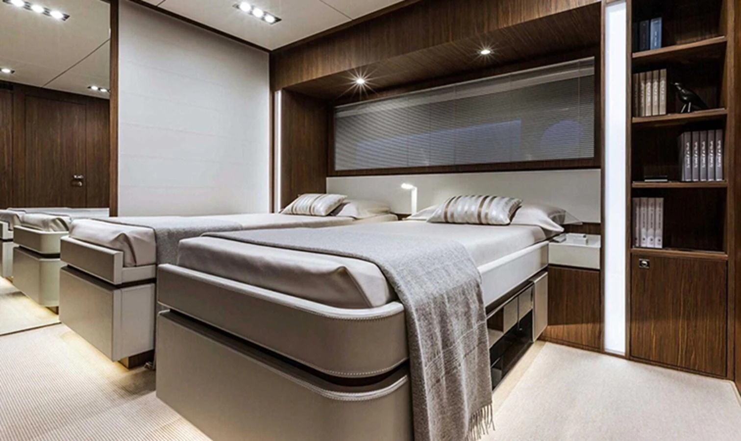 The guest stateroom features twin beds with modern, elegant decor and ample storage space. aboard ANTIOXIDANT Yacht for Sale