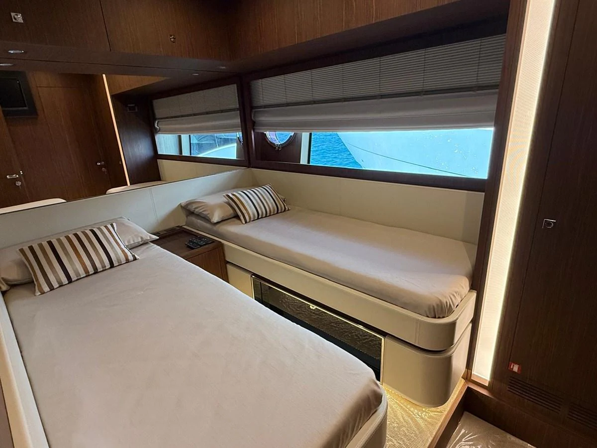 The twin stateroom offers a cozy and inviting space with two single beds and modern decor. aboard ANTIOXIDANT Yacht for Sale