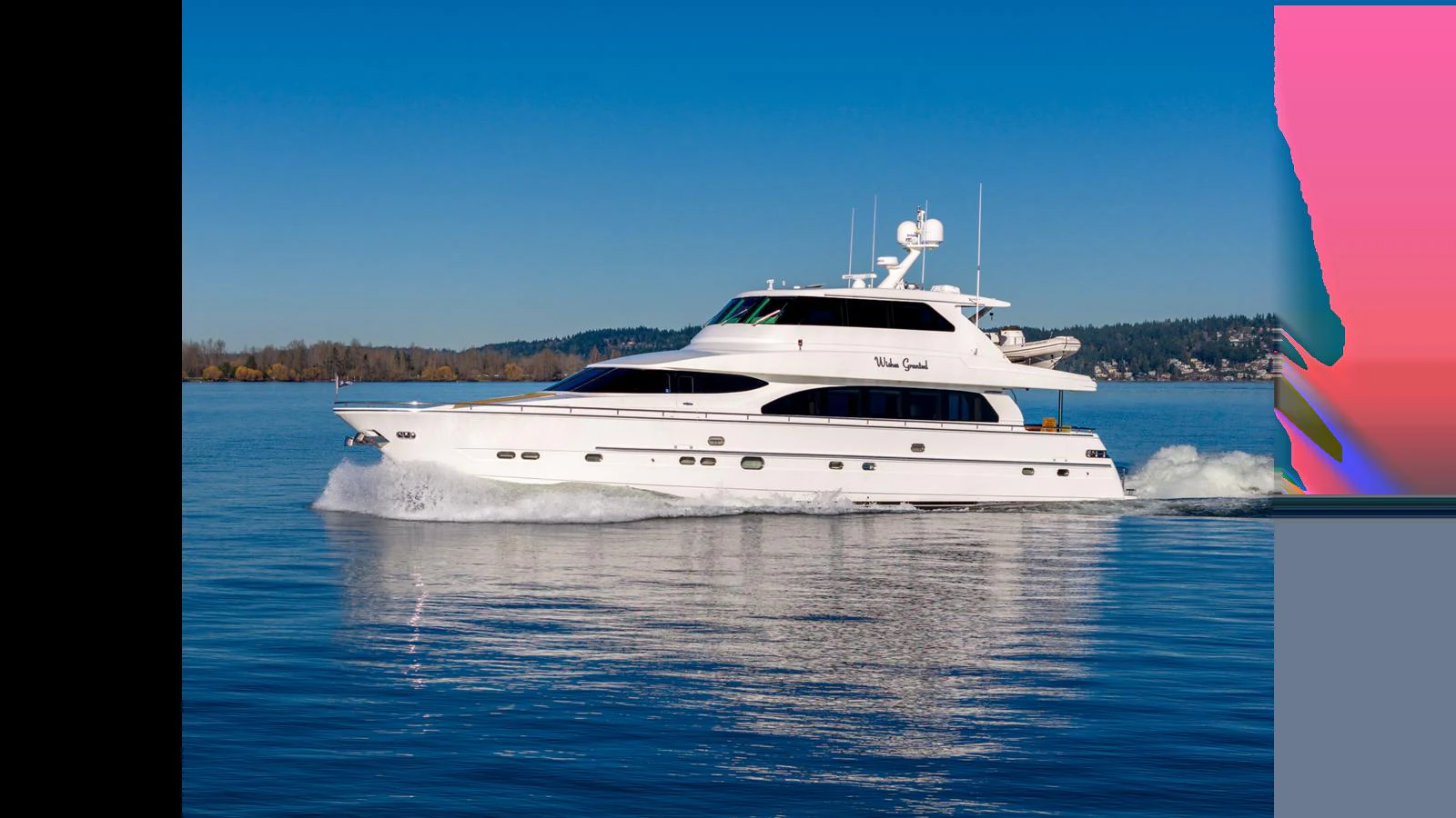 A sleek white yacht cruises smoothly on calm blue waters under a clear sky. aboard WISHES GRANTED Yacht for Sale