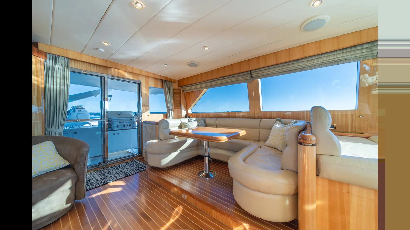 The salon features comfortable seating with large windows offering panoramic views. aboard WISHES GRANTED Yacht for Sale