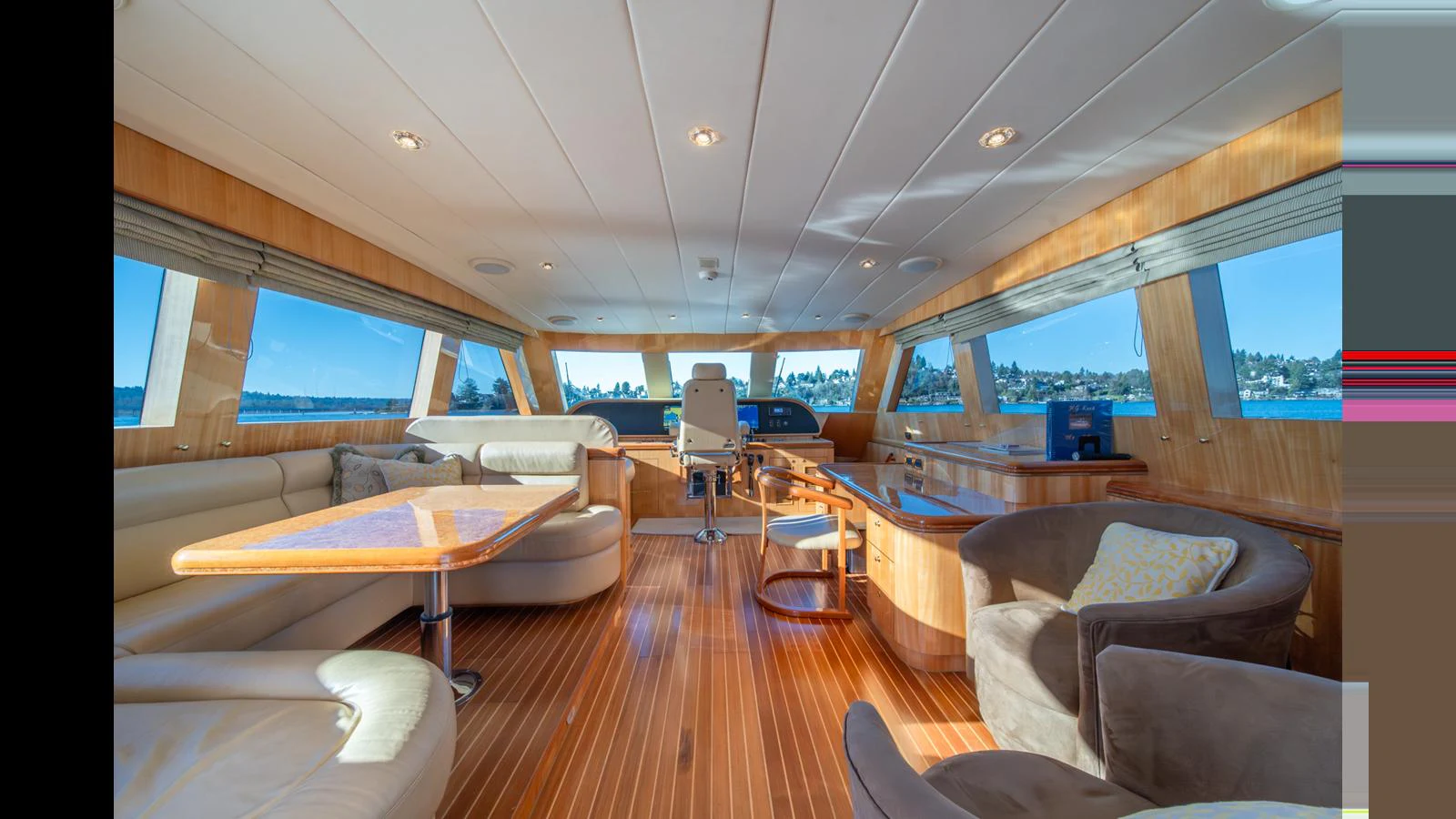 The salon features luxurious seating and panoramic windows offering stunning views. aboard WISHES GRANTED Yacht for Sale