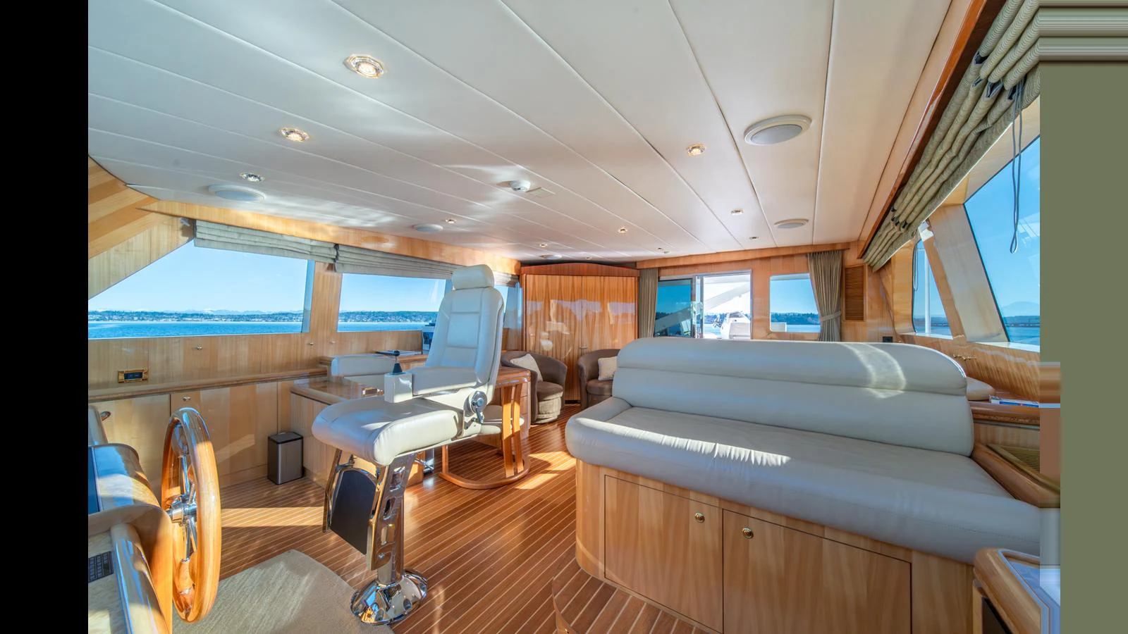 The helm area features luxurious seating and expansive windows offering panoramic views. aboard WISHES GRANTED Yacht for Sale