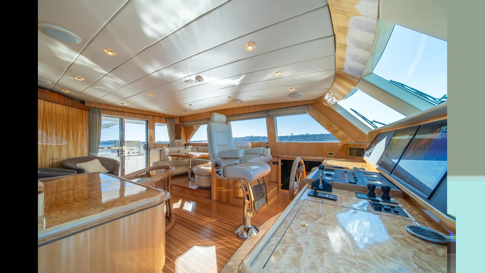 The helm station offers a luxurious and spacious area with panoramic views and high-end finishes. aboard WISHES GRANTED Yacht for Sale