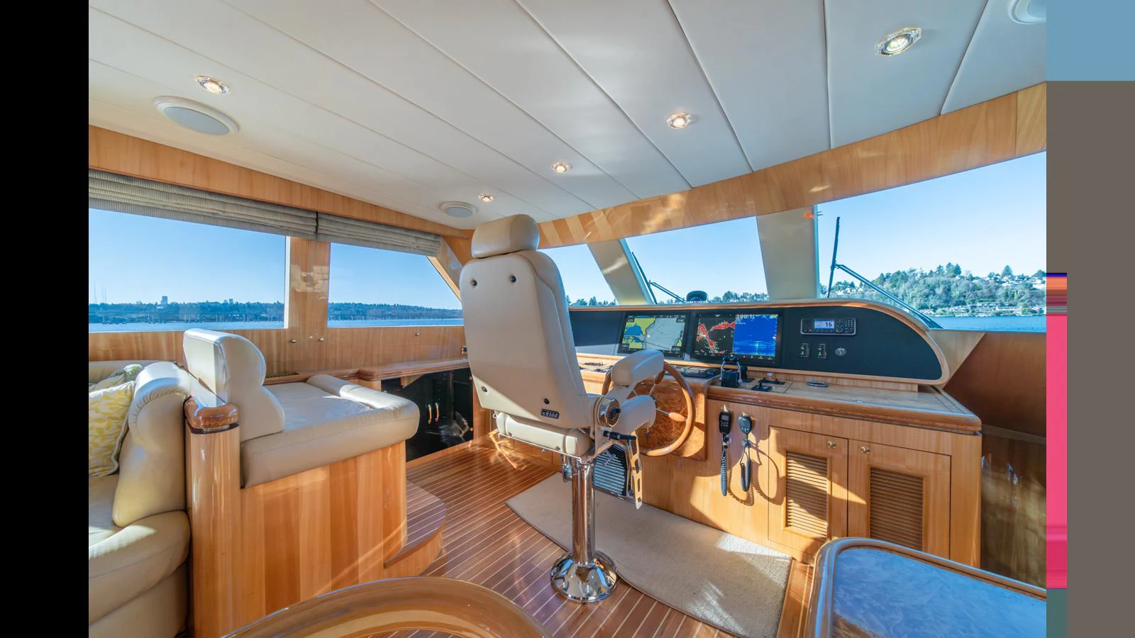 The helm station features luxurious wood finishes and panoramic views. aboard WISHES GRANTED Yacht for Sale