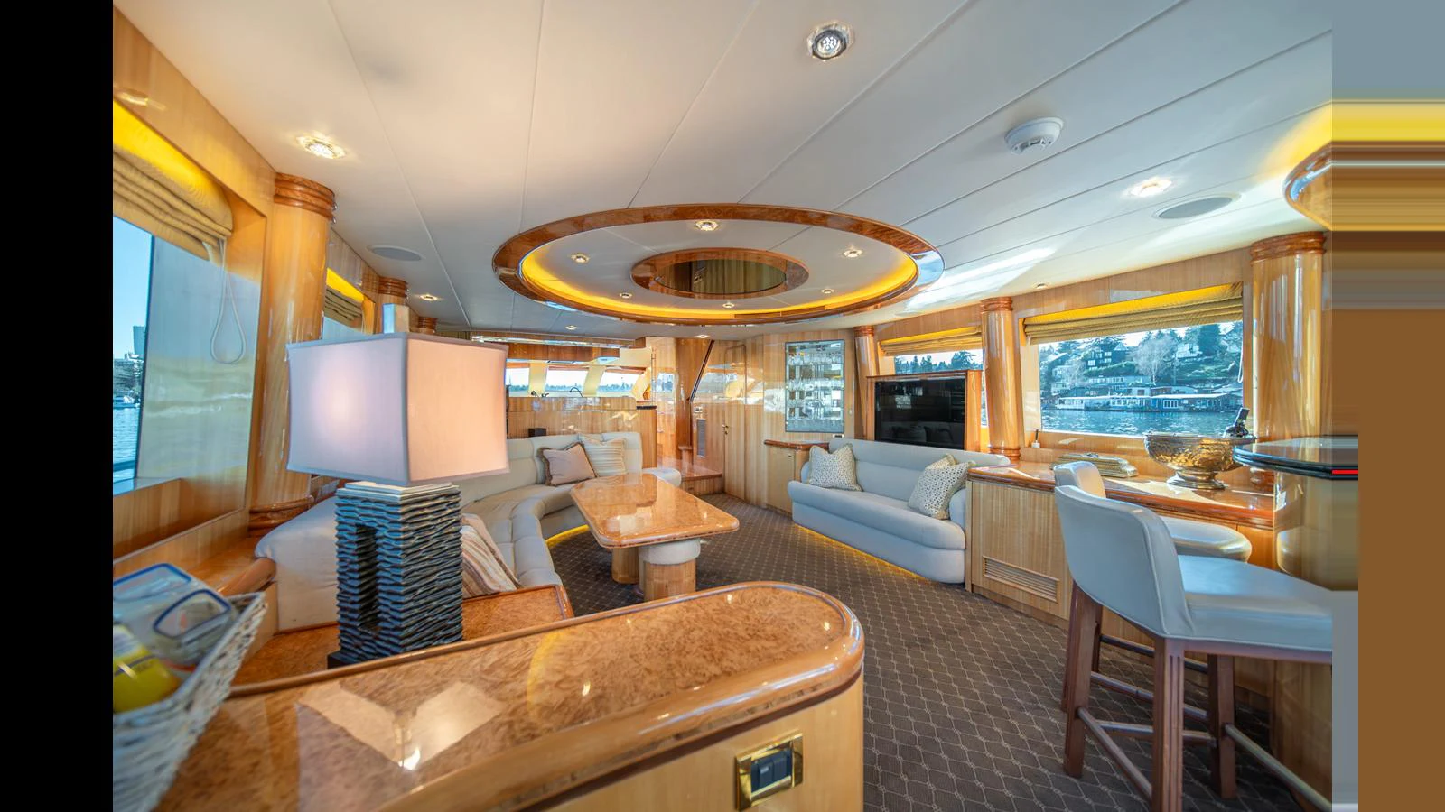 The yacht's salon features elegant furnishings and ample natural light, creating a luxurious and inviting atmosphere. aboard WISHES GRANTED Yacht for Sale