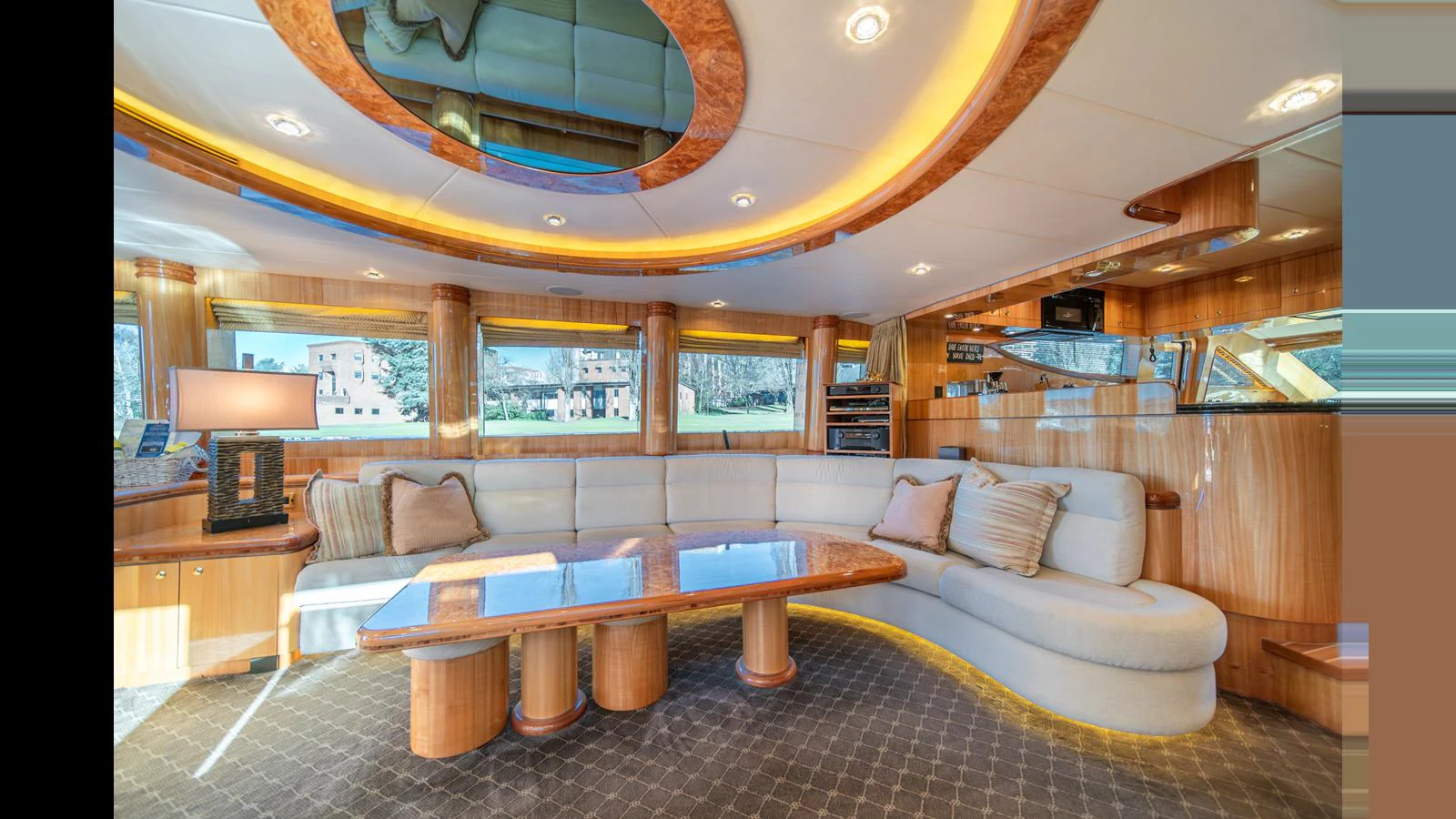 The salon features a luxurious seating area with elegant wood accents and ample natural light. aboard WISHES GRANTED Yacht for Sale