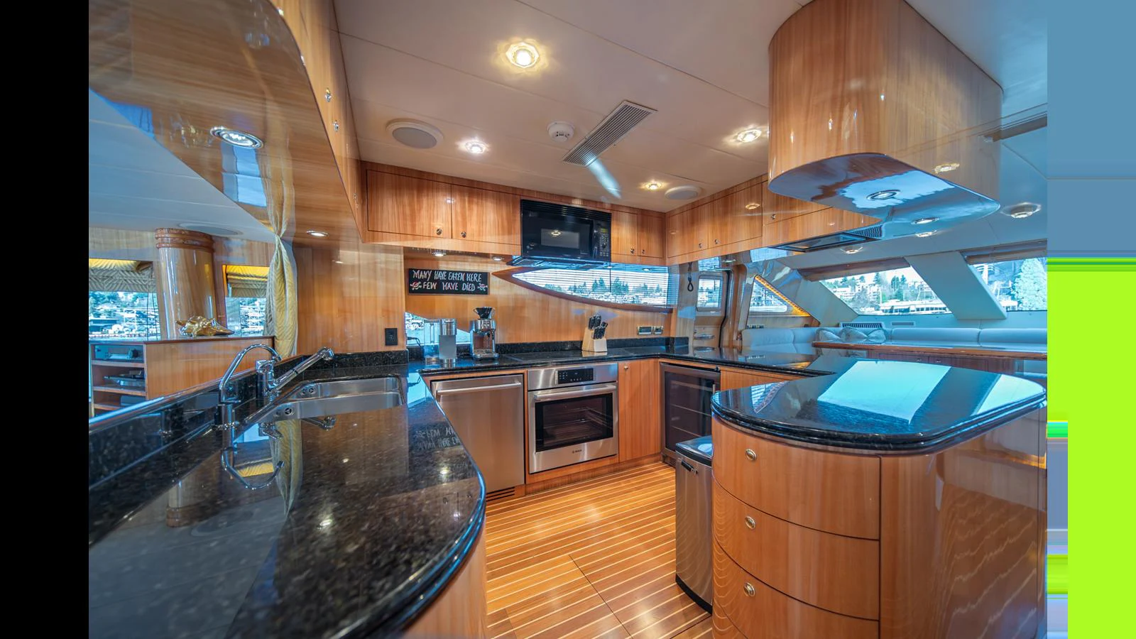 The galley features sleek wooden cabinetry, modern appliances, and ample counter space for gourmet meal preparation. aboard WISHES GRANTED Yacht for Sale