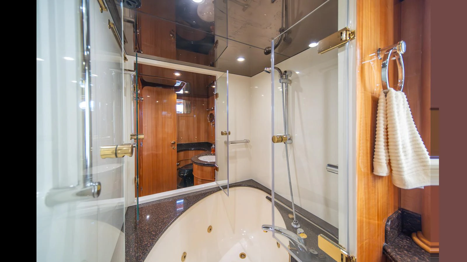 The yacht's bathroom features a luxurious bathtub and elegant fixtures. aboard WISHES GRANTED Yacht for Sale