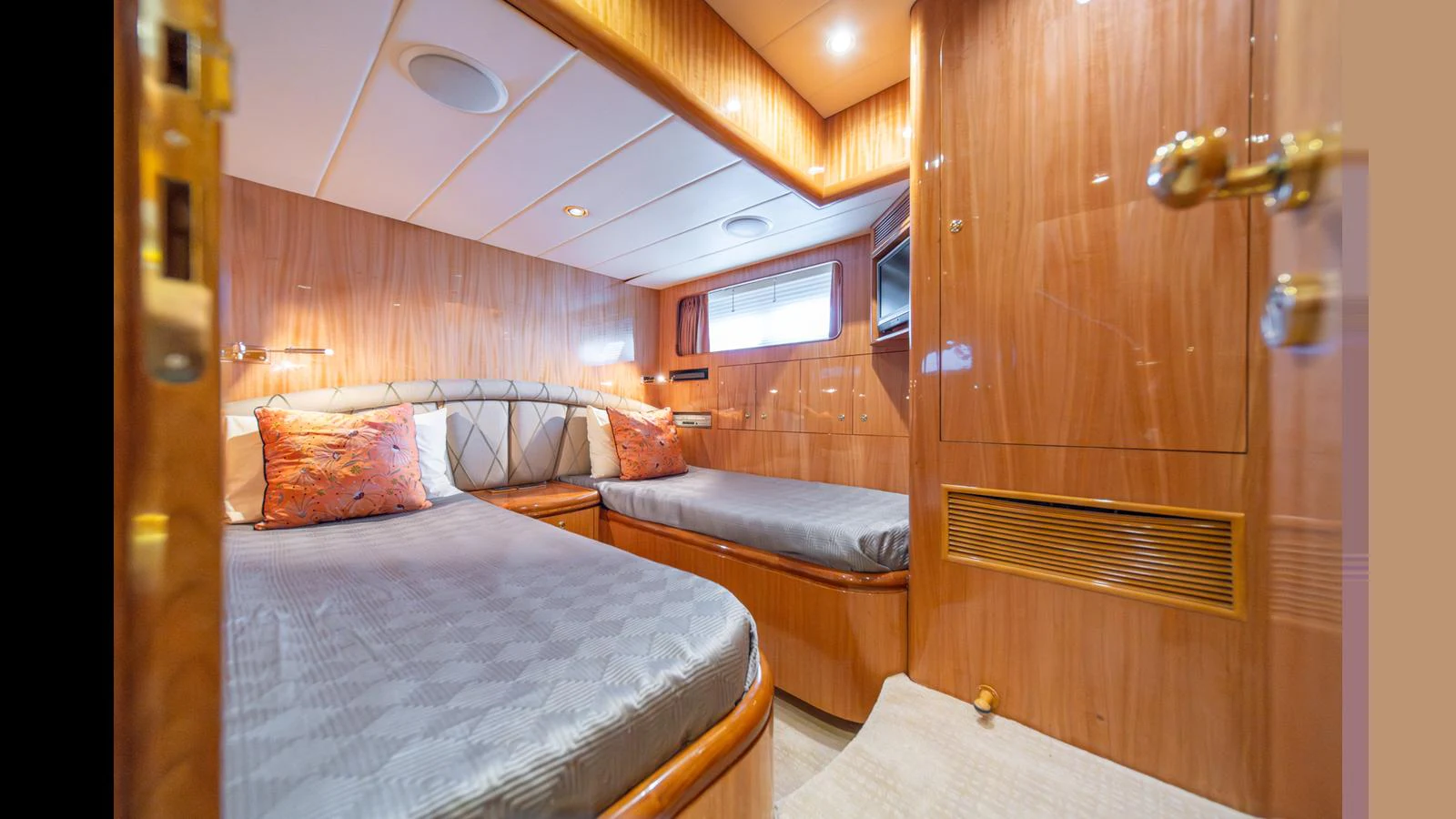 The guest cabin features twin beds with luxurious bedding and warm wood paneling. aboard WISHES GRANTED Yacht for Sale