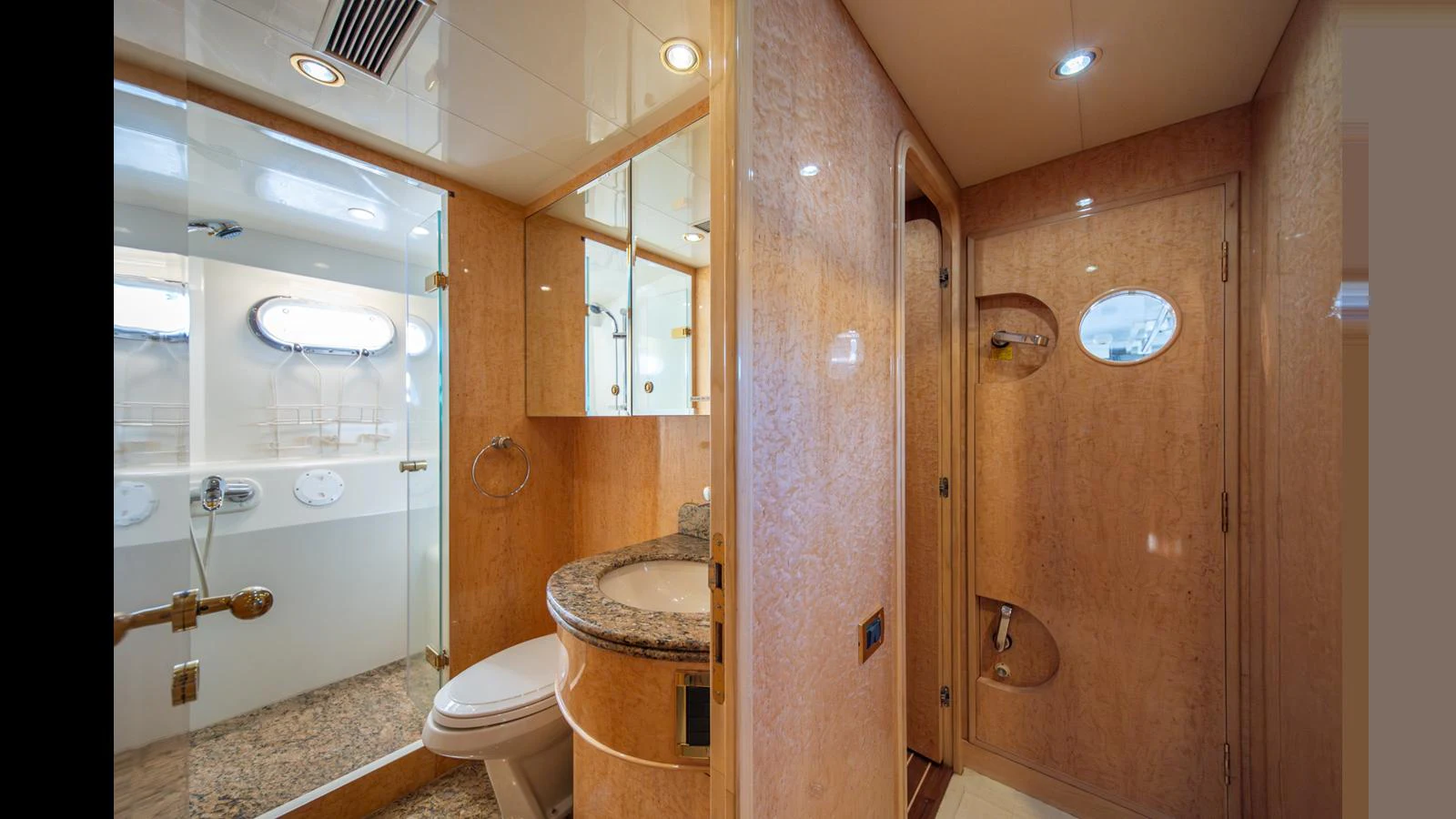 The yacht's bathroom features elegant wood paneling and modern fixtures. aboard WISHES GRANTED Yacht for Sale