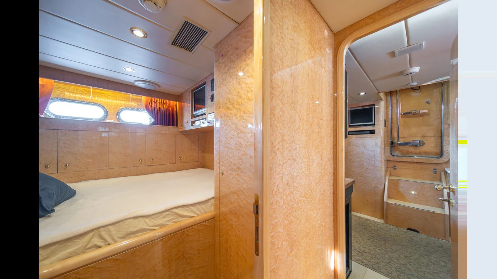 The guest cabin features a cozy bed and an ensuite bathroom with luxurious finishes. aboard WISHES GRANTED Yacht for Sale