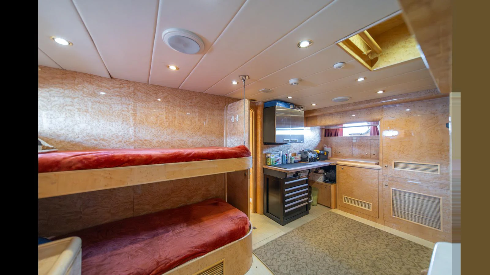 The cozy cabin features bunk beds and a compact kitchenette area. aboard WISHES GRANTED Yacht for Sale