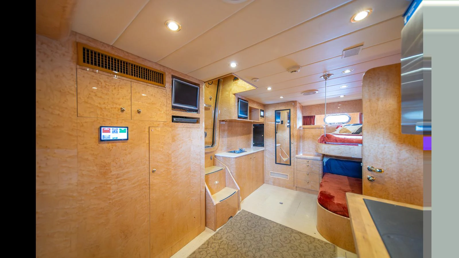 The yacht's cabin features a cozy and well-lit living space with modern amenities. aboard WISHES GRANTED Yacht for Sale