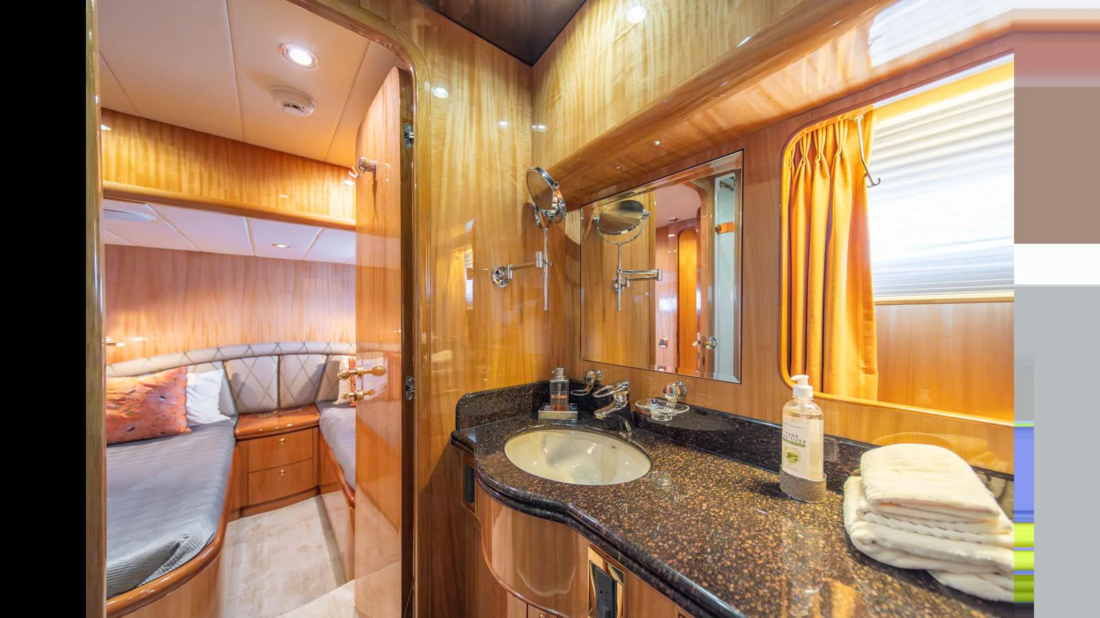 A luxurious yacht bathroom with a view into the adjacent stateroom. aboard WISHES GRANTED Yacht for Sale