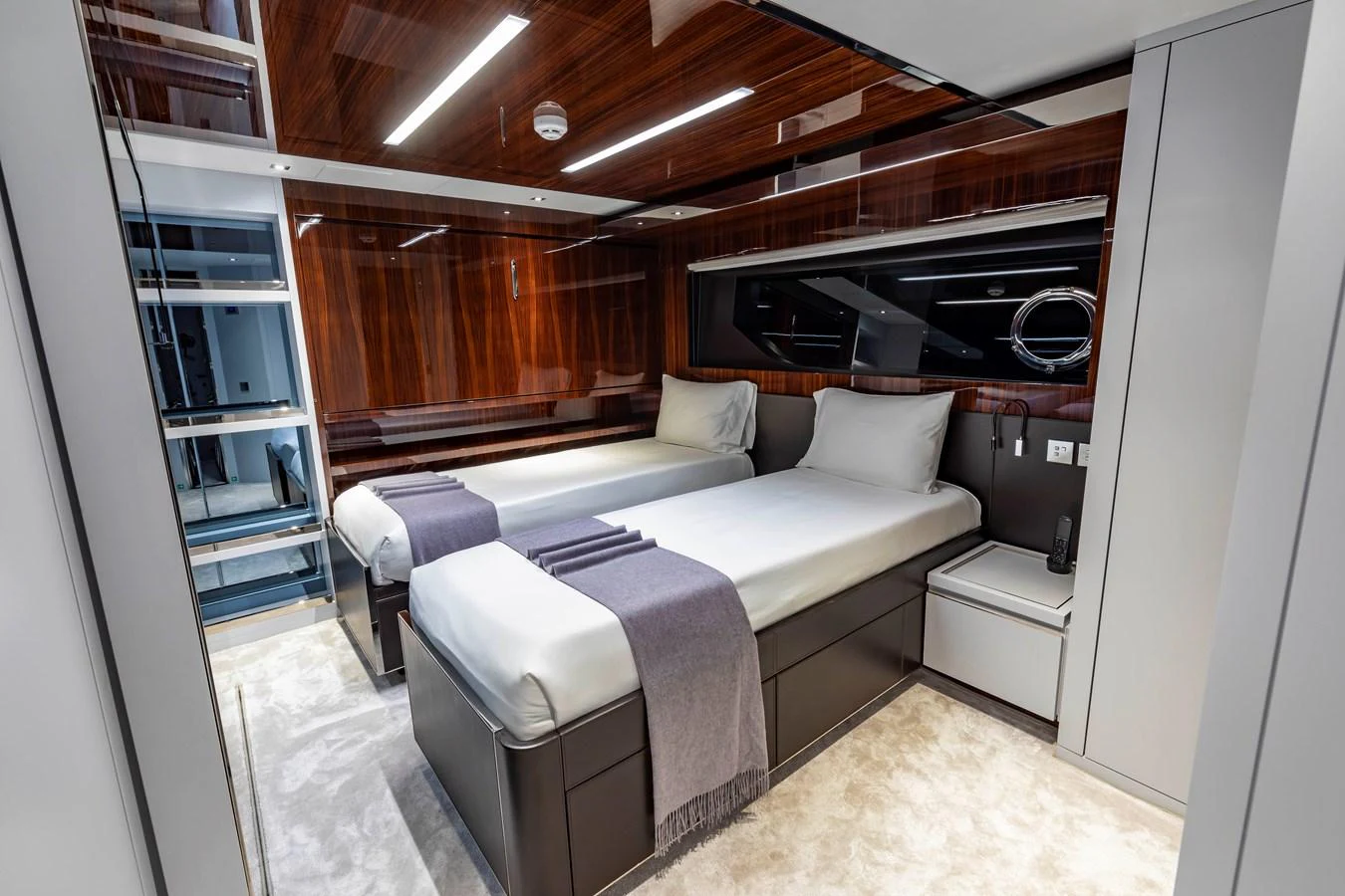 The twin stateroom features modern decor with sleek finishes and comfortable bedding. aboard NO SURRENDER Yacht for Sale
