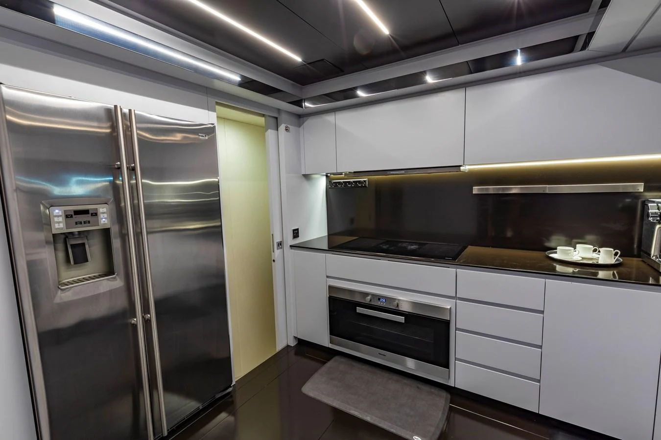 The modern galley features sleek stainless steel appliances and ample storage space. aboard NO SURRENDER Yacht for Sale