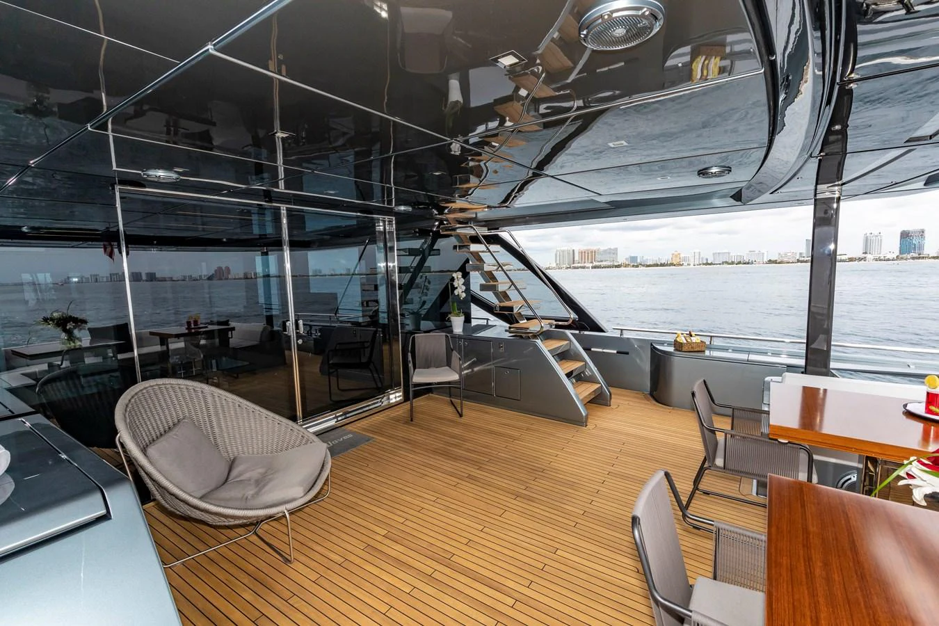 The aft deck offers a spacious and stylish area for relaxation and dining with a stunning view of the water. aboard NO SURRENDER Yacht for Sale
