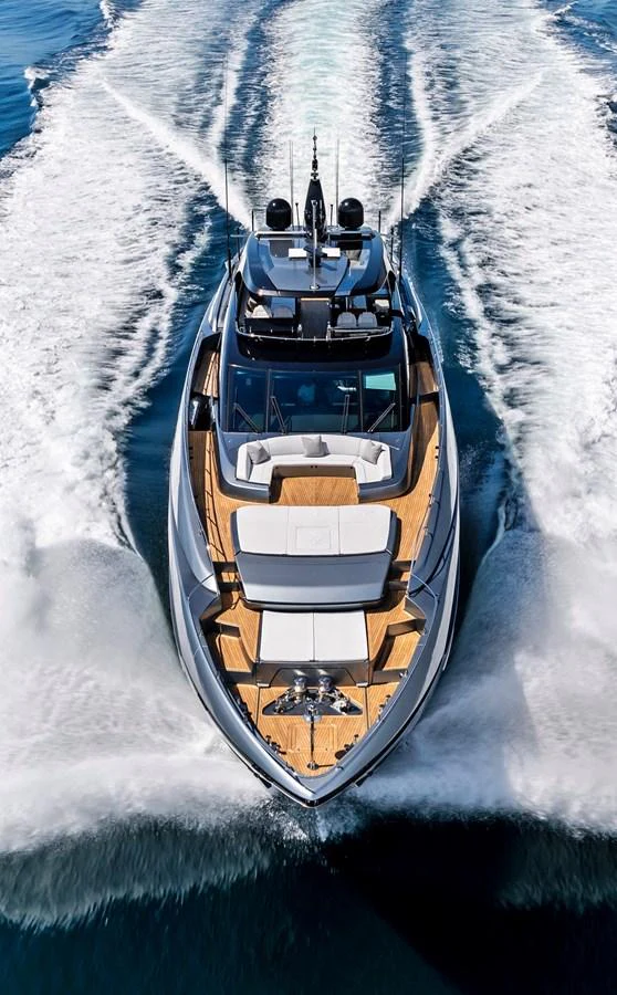 A sleek yacht cruises powerfully through the water, showcasing its modern design and luxurious deck layout. aboard NO SURRENDER Yacht for Sale