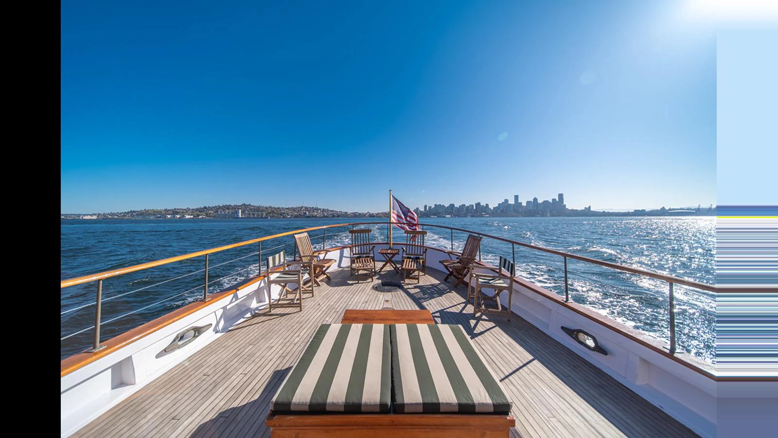 The aft deck offers a spacious and inviting area with comfortable seating and stunning views of the water and city skyline. aboard BLUE PETER Yacht for Sale