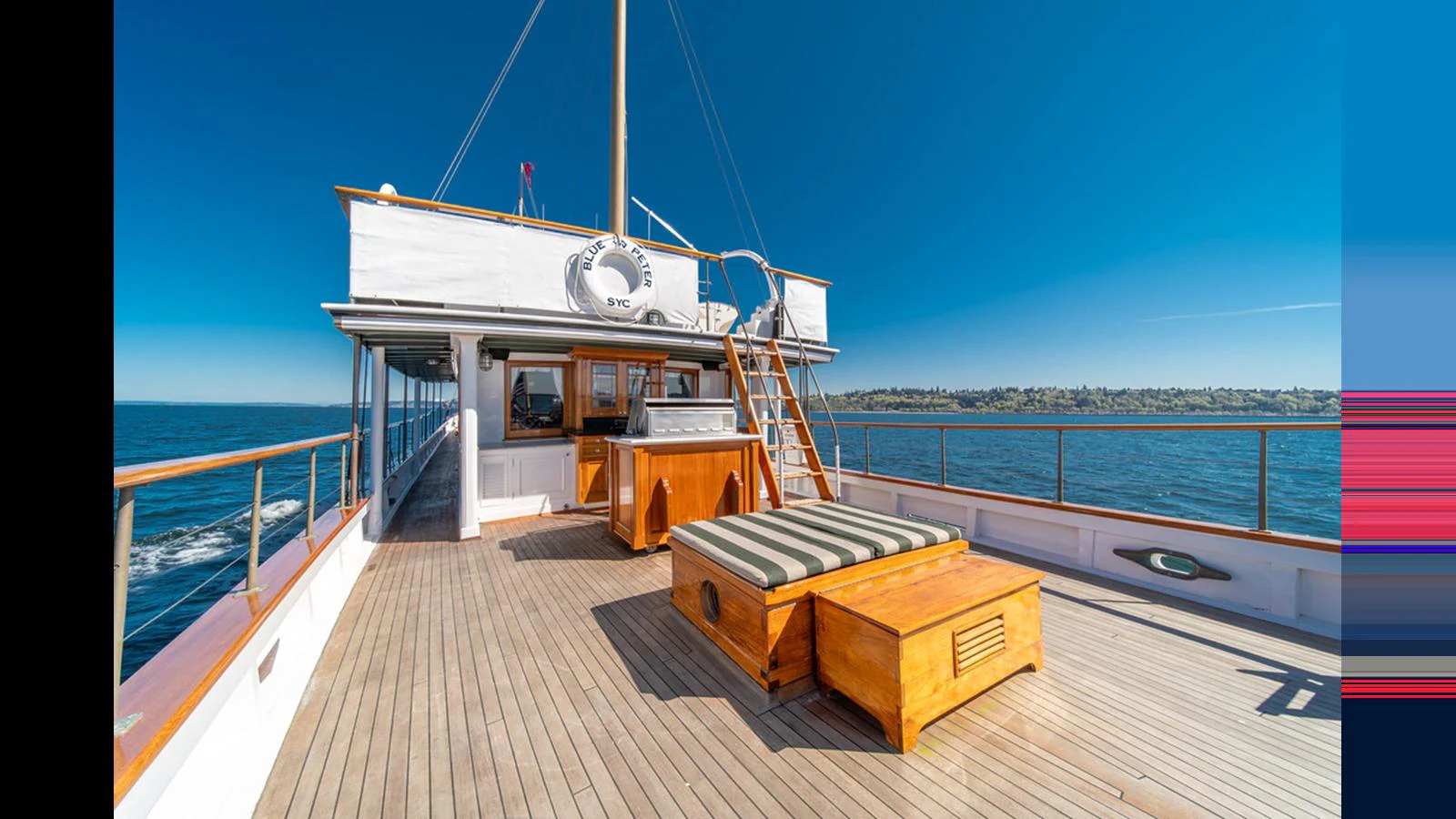 The sundeck features a spacious lounging area with a hot tub and comfortable seating, perfect for relaxation under the sun. aboard BLUE PETER Yacht for Sale