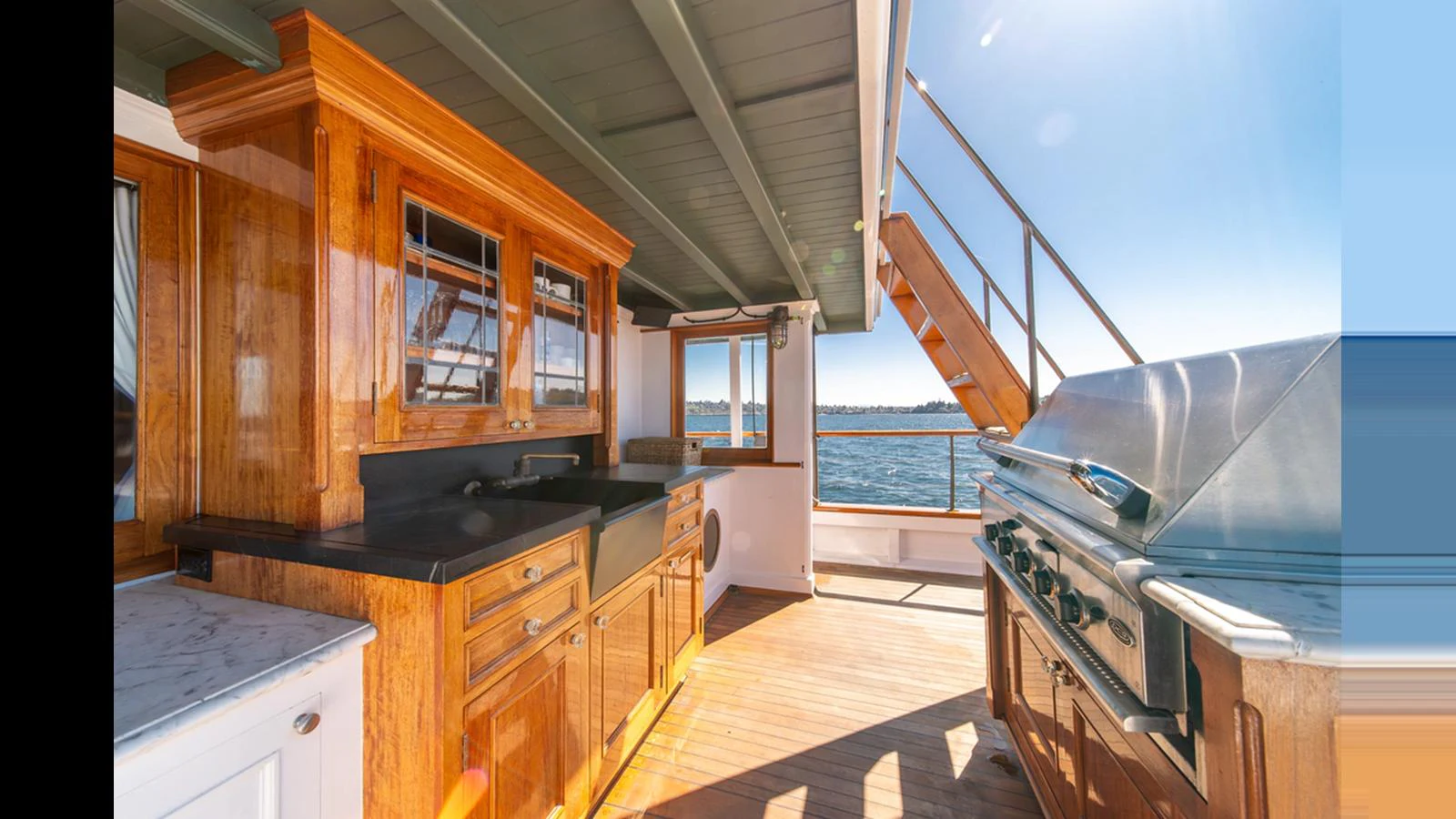 The yacht features a well-equipped outdoor galley with a grill and ample counter space, perfect for alfresco dining. aboard BLUE PETER Yacht for Sale