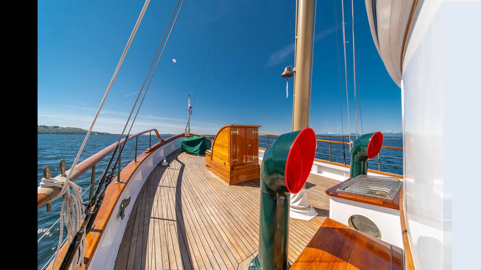 A spacious wooden deck with polished fittings and a clear view of the sea. aboard BLUE PETER Yacht for Sale