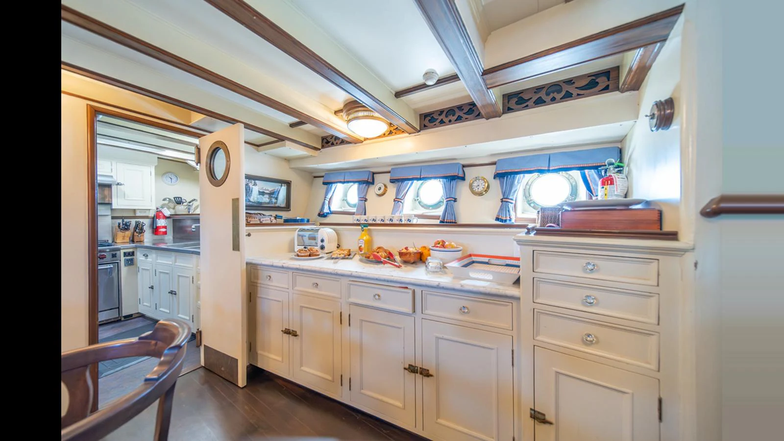 The yacht's galley is well-equipped with ample counter space and classic cabinetry, creating a warm and inviting atmosphere. aboard BLUE PETER Yacht for Sale