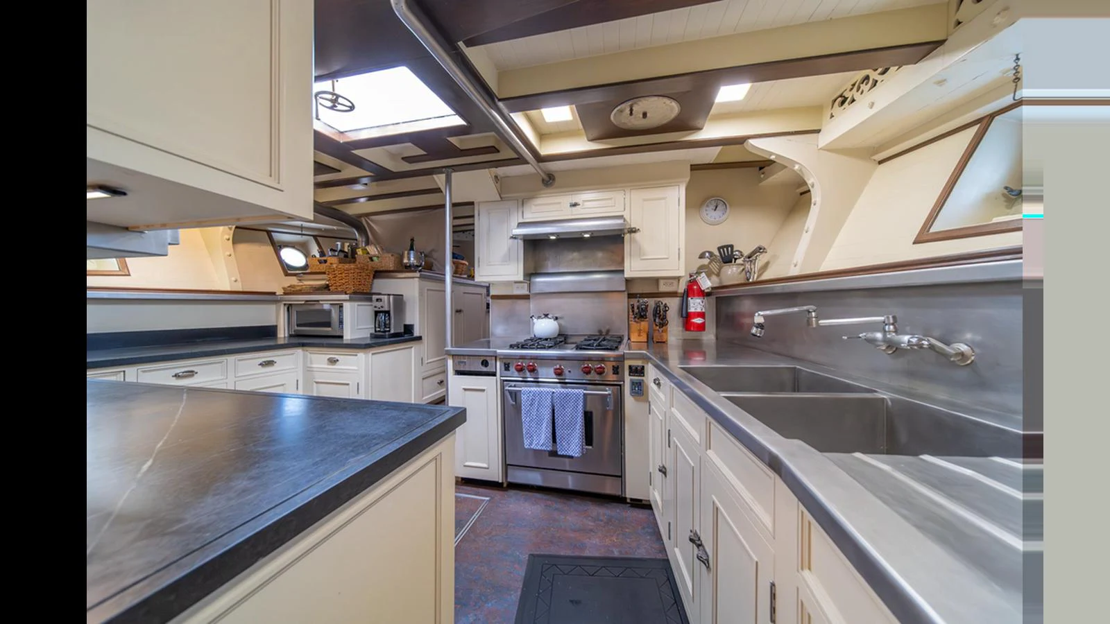 The yacht's galley features modern appliances and ample counter space for gourmet meal preparation. aboard BLUE PETER Yacht for Sale