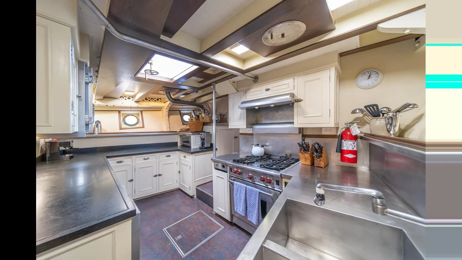 The yacht's galley is equipped with modern appliances and ample counter space, perfect for gourmet meal preparation. aboard BLUE PETER Yacht for Sale