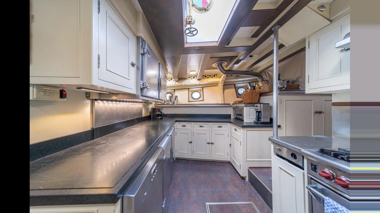 The yacht's galley is equipped with modern appliances and ample counter space, providing a functional and stylish cooking area. aboard BLUE PETER Yacht for Sale