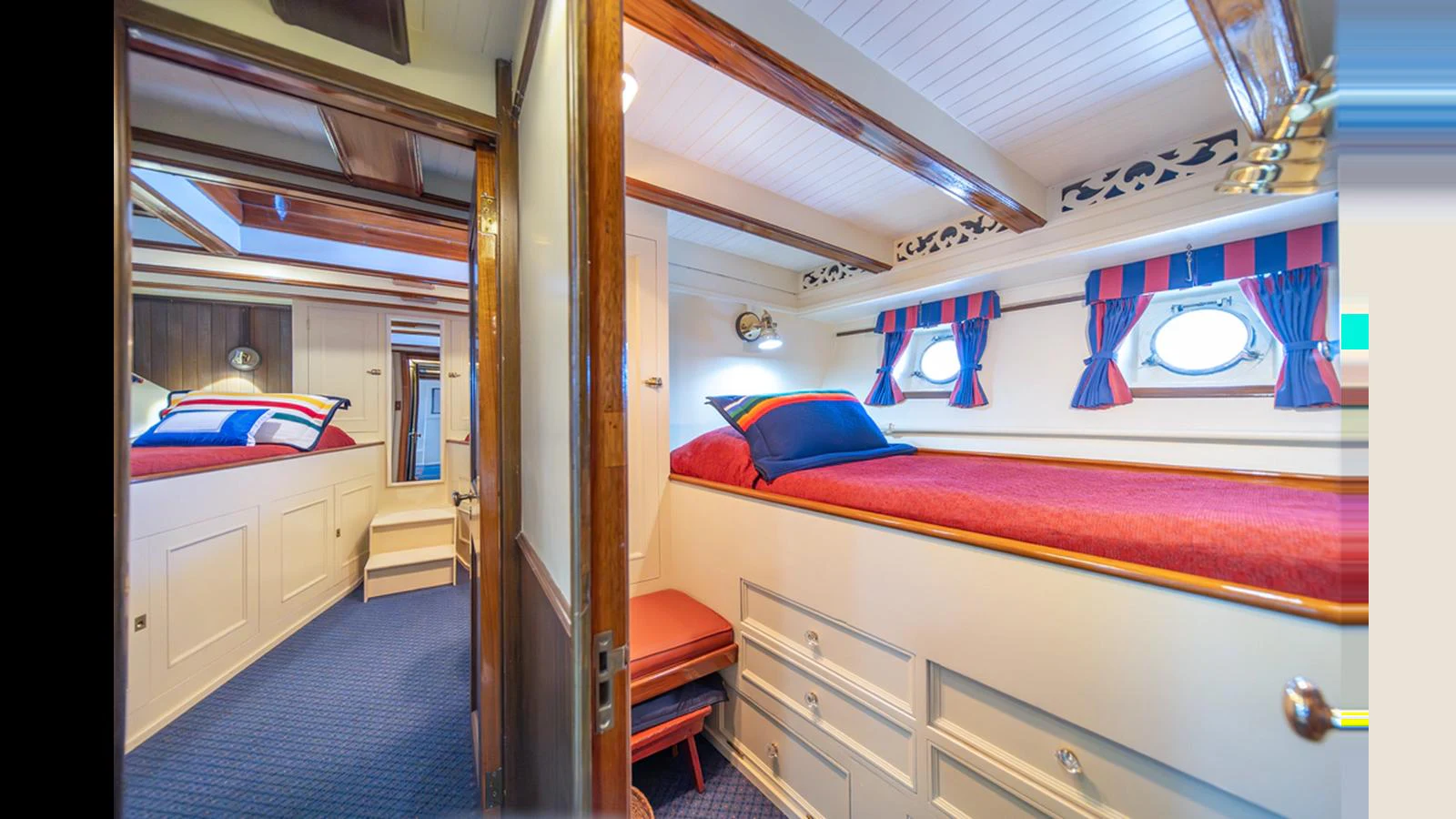 The guest cabin features cozy bunk beds with nautical-themed decor and ample storage space. aboard BLUE PETER Yacht for Sale