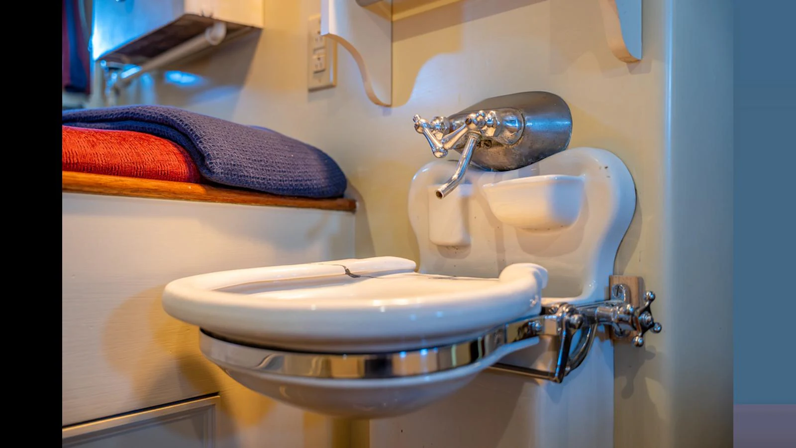The image showcases a compact and well-appointed bathroom with a sleek sink and modern fixtures. aboard BLUE PETER Yacht for Sale